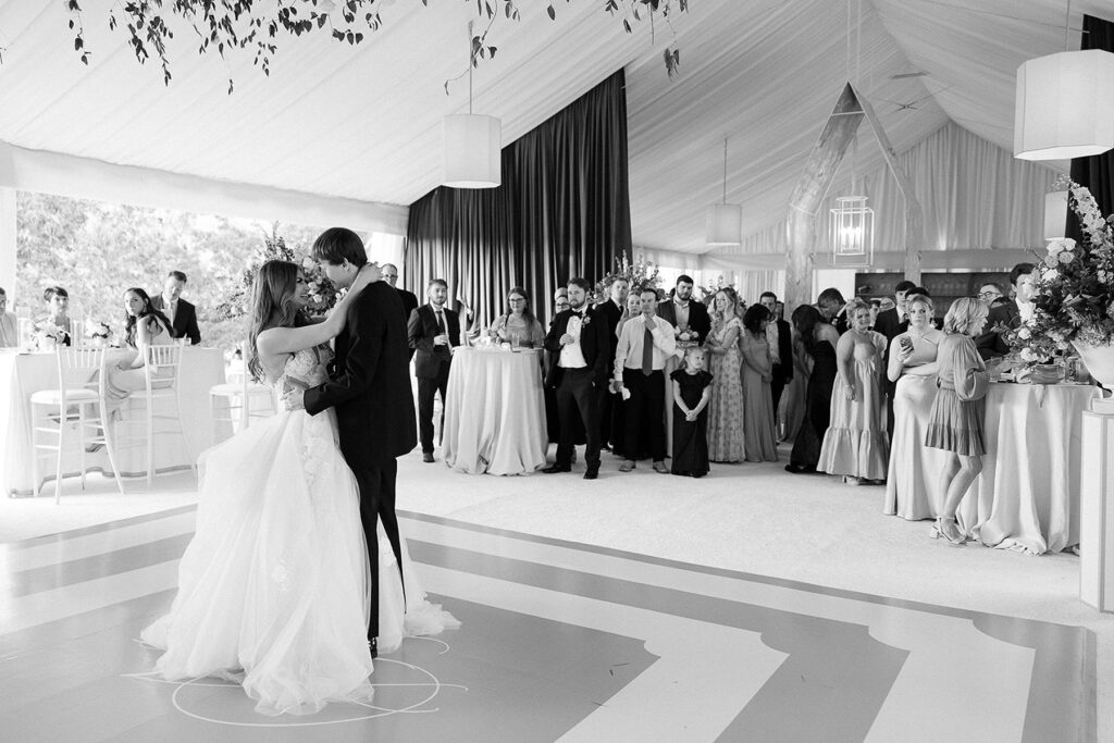 Bride and groom dance at luxury tent wedding.